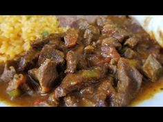 the meal is prepared and ready to be eaten on the plate, including rice and meat