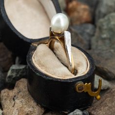 This vintage pearl ring is crafted in 14k yellow gold. The shoulders feature a Florentine finish in white gold accents. It is currently a size 6. Heirloom Pearl Ring In Yellow Gold With High Luster, Formal 14k Gold Pearl Ring With High Luster, Heirloom Pearl Ring With High Luster For Formal Occasions, Heirloom Pearl Ring With High Luster For Formal Events, Formal Heirloom Pearl Ring With High Luster, Heirloom Style Formal Pearl Ring With High Luster, Heirloom High Luster Pearl Ring For Formal Occasions, Classic High Luster Pearl Ring For Anniversary, Antique 14k Gold Pearl Ring For Anniversary