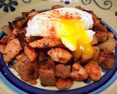 an egg is sitting on top of some tater tots