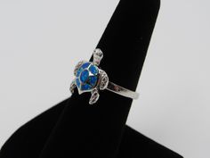 Top of ring height: 16.7mm Top of ring width: 14.4mm Band width: 2.4mm Shank width: 2.4mm Stone material: blue lab created opal Stone setting: inlay setting Metal: 925 sterling silver Plating: rhodium plated Finish: high polish Ring box color in picture may not be the color you receive. All orders ship via USPS first class mail. I will process your order and ship it within 1 business day of payment. I only ship within the United States. Please don't hesitate to message me with any questions or c Genuine Pearl Necklace, Opal Band, Sweet Necklace, Stone Material, Minimalist Gifts, Silver Tops, Stone Setting, Opal Stone, Blue Band