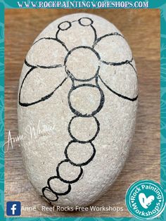 a rock with an image of a flower painted on it and the words art rocks free workshop