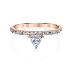 a rose gold engagement ring with a pear shaped diamond in the center and side stones