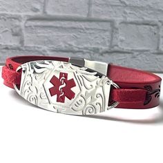 The Forrest medical alert wristband is simple, modern, and handmade to order. The genuine red leather strap is a high-quality embossed leather, and the stainless-steel faceplate features the international medical alert symbol. The Forrest medical alert bracelet can be made to fit both adults and children. The bracelet is secured with a stainless metal clasp. Note: The clasp is stainless steel and magnetised so please let us know if you wear a pacemaker - we will change the clasp - GENUINE LEATHER - FREE PERSONALISED ENGRAVING -Up to 3 lines of text (Maximum 25 characters per line) - FREE VELVET TRAVEL POUCH - FREE UK SHIPPING - FREE GIFT BOX - FREE MEDICAL CARD Can my item be engraved? Yes - on the reverse of the steel medical alert plate. Up to 3 lines with maximum of 25 characters per li Medical Alert Symbol, Medical Card, Medical Alert Jewelry, Medical Alert Bracelet, Medical Id Bracelets, Medic Alert Bracelets, Medical Bracelet, Free Medical, Medical Alert