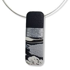 Details: 3/4" x 2-1/8" (20mm x 55mm) Long Rectangle Pendant Marbled colors of Black, White and Sparkly Silver This item is ready to ship. 18" Sterling Silver Chain included Other Sterling Silver Chain Lengths are available A dance of soft colors, unique textures, and patterns that invigorates the imagination because your figures will most likely want to play with. A pendant that is full of possibilities! It is a one-of-a-kind unique statement piece that is meant to attract attention. It will acc One Of A Kind Unique Rectangular Pendant Jewelry, Silver Rectangular Pendant Jewelry With Polished Finish, Modern Rectangular Pendant Jewelry With Polished Finish, Unique Rectangular Pendant With Natural Stones, Black Minimalist Rectangular Pendant Jewelry, Unique Textures, Rectangle Pendant, Unique Pendant, Sterling Silver Chain