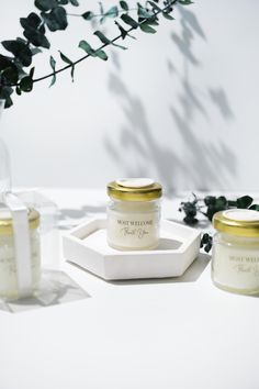 three jars of body cream sitting on a table