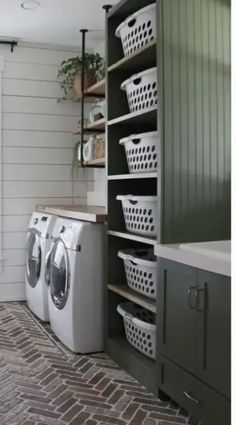 a washer and dryer in a laundry room with shelving on the wall