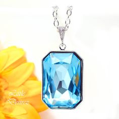 "Glamorous, eye catching and sparkly large Aquamarine pendant necklace with stunning Swarovski Emerald Cut Fancy Stone. These dramatic octagon shaped crystals have a vintage feel to them and are designed with precise machine-cut facet patterns that produce the signature Swarovski sparkle! The impression these bold stones will leave will last a lifetime! Necklace made with: - the gorgeous and Genuine 27x18.5mm Aquamarine Blue Swarovski Emerald cut fancy stone, set in silver plated setting - Hypoa Shaped Crystals, Fancy Stones, Aquamarine Pendant, Large Crystal, Blue Pendant, Blue Bridesmaids, Bridesmaid Necklace, Aquamarine Blue, Blue Necklace