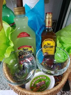 a basket filled with bottles of alcohol and condiments