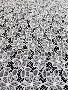 a white lace tablecloth with flowers on it