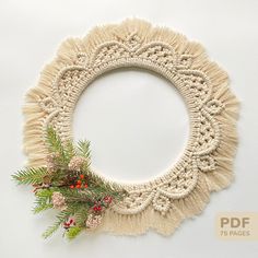 a crocheted wreath is hanging on the wall with holly and red berries around it