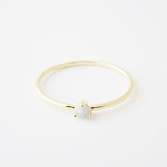 Elegant Adjustable Opal Stackable Rings, Minimalist Gold Opal Birthstone Ring, White Minimalist Adjustable Opal Ring, Adjustable White Minimalist Opal Ring, Minimalist Opal Stackable Promise Rings, White Adjustable Minimalist Opal Ring, Adjustable Round Moonstone Ring In Minimalist Style, Minimalist Gold Opal Rings, Minimalist Gold Opal Ring As Birthstone