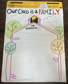 a paper with the words our class is a family on it and trees in front