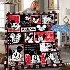 a woman holding up a mickey mouse blanket