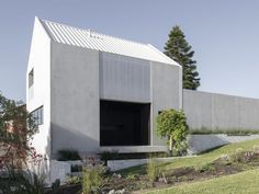 the house is made out of concrete and has an open door on it's side