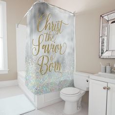 a bathroom with a shower curtain that says christ the savor is born