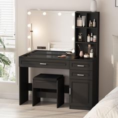 a black vanity table with lights on it in a bedroom next to a white bed