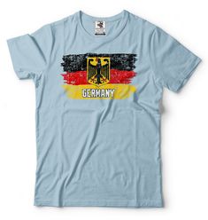 "Germany T-Shirt German Patriot Germany Flag German Diaspora Nationality Tee Shirt This ULTRA COTTON UNISEX T-shirt is made of Pre-shrunk 100% cotton, 6.1-ounce. * Seamless double-needle 7/8\" collar, Double-needle sleeves and hem, Taped neck and shoulders Our T Shirts and Hoodies are Printed by advanced technology Digital Printer on 100% Ultra Cotton tees and hoodies . We use waterbased textile ink, Safest ink type for everyone. Each T shirt is Made individually and double checked for quality b Cotton Fan Apparel T-shirt With Front Print, Cotton Crew Neck T-shirt With Flag Print, Blue Cotton Tops With Flag Print, Sporty Cotton T-shirt With Flag Print, Cotton Top With Flag Print For Streetwear, Basic Cotton T-shirt For Fan Merchandise, Cotton Graphic Tee With Flag Print, Casual Flag Print Top For Fans, Cotton Flag Print Crew Neck T-shirt