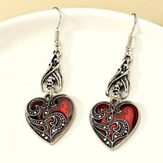 New Enamel Heart Dangle Earrings Goth Bat Red Silver Tone Fish Hook Gift Brand New In Original Package No Price Tags Attached Great Gift Elegant Red Enamel Heart Shaped Dangle From Upside Down Bat Silver Tone Dangle Fish Hook Style Earrings Goth Punk Vampire **Check Out Y Other Items...Bundle & Save $$ On Shipping** (T1a63) Tags Home, Country ,Collectable, Vintage, Figurine ,Office, Boho, Hippie, Stylish, Gift, Fashion, Surfer, Vacation, Beach, Unisex, Vegan, Minimalist, Western, Southwest, Nati Silver Gothic Earrings For Valentine's Day, Gothic Metal Earrings For Valentine's Day, Red Heart Charm Metal Earrings, Gothic Dangle Heart Earrings For Gift, Gothic Dangle Earrings For Valentine's Day, Red Nickel-free Dangle Heart Earrings, Red Sterling Silver Dangle Heart Earrings, Red Sterling Silver Pierced Heart Earrings, Vintage Red Heart Earrings For Pierced Ears