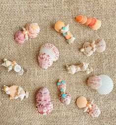 several seashells are arranged on a burlap surface