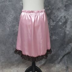 "Lovely Hi-low skirt in Rose Pink Satin with a ruffle trim in Brown Lace. The skirt is a size Medium and has an elastic waist. It will fit waist sizes from 30.5 - 36 inches (76-91.5 cm). The front length is 14.5 inches (37 cm) and back length is 25 inches (63.5 cm). BLOUSE AND WAIST CINCHER ARE NOT INCLUDED. THIS IS A FINISHED ITEM AND WILL SHIP WITHIN 48 HOURS OF COMPLETED PAYMENT. ✿This piece has been handmade entirely by me from design to completion - I do not use any manufacturers in any of Pink Satin Skirt, Natural Linen Dress, Hi Low Skirts, Skirt Ruffle, Steampunk Corset, Steampunk Cosplay, Pastel Print, Waist Cincher, Satin Skirt