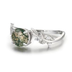 Break free from your thoughts and marvel at the beauty of our nature-inspired Between the Leaf Round Moss Agate Ring©. The astonishing round-shaped moss agate stone sits at the center of gracefully sculpted silver leaves with round gems for a hint of sparkle. ✦ Available in both 14K white gold vermeil (14K white gold plated over a sterling silver base) and 10K solid white gold. Round Moss Agate Jewelry With Natural Stones, Nature-inspired Agate Rings With Natural Inclusions, Nature-inspired Moss Agate Jewelry With Natural Inclusions, Silver Moss Agate Ring With Natural Inclusions, Nature-inspired Agate Gemstone Rings, Nature-inspired Round Jewelry With Natural Stones, Nature-inspired Moss Agate Jewelry For Anniversary, Nature-inspired Round Cabochon Jewelry, Nature-inspired Moss Agate Round Rings