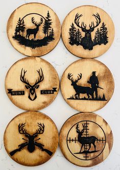 four wooden coasters with deer and hunters on them