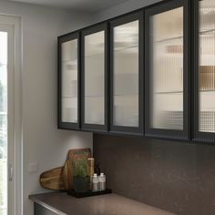 a kitchen with black cabinets and counter tops