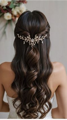 a woman with long hair wearing a bridal headpiece