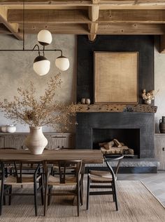 a dining room table and chairs in front of a fire place with an open fireplace