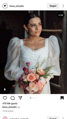 a woman wearing a white dress holding a bouquet of flowers in front of her face