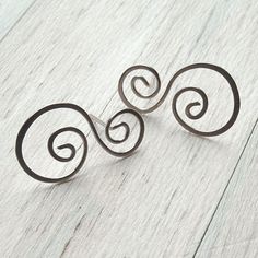 Stunning water element earrings in solid sterling silver. These spirals have been hand formed from a single piece of sterling silver wire into these attractive post earrings. Lightly sanded and buffed to a nice sheen, the post ends have also been carefully smoothed for comfortable wear. Coiled wave earrings are approximately 23mm (7/8 inch). Come take a peek at my other designs: http://www.etsy.com/shop/ArtistiKat Photos and content © K Davis PLEASE read shop policies prior to purchasing. Silver Spiral Wrap Earrings In Sterling Silver, Spiral Sterling Silver Earrings For Gift, Spiral Sterling Silver Earrings As Gift, Minimalist Silver Swirl Earrings, Minimalist Sterling Silver Swirl Earrings, Silver Swirl Wire Wrapped Earrings, Handmade Silver Swirl Earrings, Nickel Free Silver Swirl Earrings, Unique Swirl Earrings As Gift