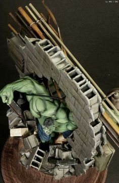 the hulk statue is on top of a wooden stand with chopsticks in it