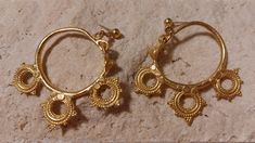 Byzantine earrings, 6th century AD, or as they are some times called Byzantine Ear Pendants. They are gold plated Pewter.  Minimal wear to the gold finish on some of the high tips of metal but in fantastic condition for earrings from the 1950s. These earrings have three double sided decorative wheel designs.  Similar earrings can be seen in the Brooklyn Museum.  https://www.brooklynmuseum.org/opencollection/objects/17469 Very lightweight and 2.5 inches in length. Byzantine Earrings, Egyptian Jewelry, Gold Finish, Jewelry Earrings Hoops, Earings Piercings, Favorite Things Gift, Jewelry Inspiration, Hoop Earrings, Jewelry Earrings