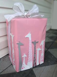 a pink gift box with giraffes on it