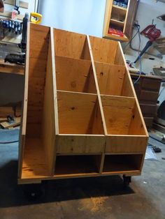 a large wooden box sitting on top of a workbench in a garage next to tools