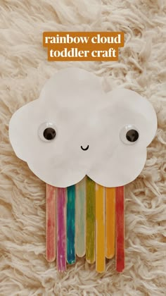 a cloud made out of popsicle sticks with the words rainbow cloud toddler craft on it