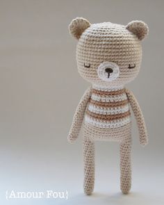 a crocheted teddy bear with eyes closed