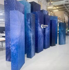 several tall blue sculptures in a large room