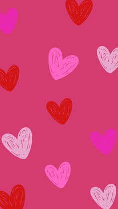 hearts drawn in pink and red on a pink background