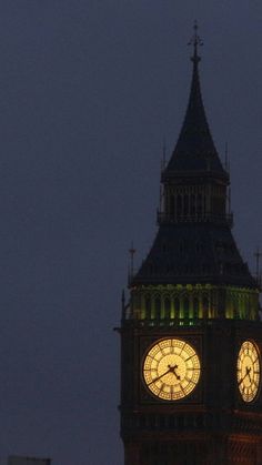 the big ben clock tower towering over the city of london, england at night time