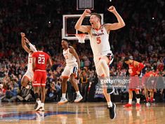 a basketball player jumping in the air with his arms wide open as he looks to pass