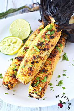 grilled corn on the cob with lemon wedges and garnishes