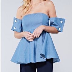 Light Denim Color Off Shoulder Top With Detailed Button Cup Sleeves. Back Zip And Lined. Chic Short Sleeve Denim Top For Day Out, Trendy Tops With Snap Buttons For Spring, Trendy Spring Tops With Snap Buttons, Chic Denim Button-up Top, Spring Light Wash Denim Top With Button Closure, Chic Medium Wash Tops For Day Out, Spring Denim Tops With Button Closure, Spring Medium Wash Tops With Button Closure, Spring Medium Wash Top With Button Closure