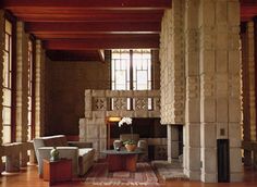 a living room filled with lots of furniture next to a fire place in a building