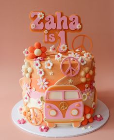 a cake decorated with flowers and the words zaha is 1 on top of it