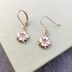 "⇩CLICK BELOW FOR DETAILS⇩ ✦Plumeria flower charms are cast from sterling silver and dipped in 18k rose gold and dangle from 18k rose gold vermeil ear wires. The flowers measure about 12mm in diameter (about 1/2 inch) and have a total length of about 1-1/4\". So light weight and easy to wear. Each earring comes with a hypoallergenic rubber grommet to hold the ear wire securely in place. ✦Matching necklace available: https://www.etsy.com/listing/573410054 ✦Earrings also available in sterling silv Rose Gold Dangle Jewelry For Mother's Day, Delicate Rose Gold Jewelry For Mom, Delicate Rose Gold Jewelry As Gift For Mom, Dainty Pink Gold Flower Jewelry, Rose Gold Flower Earrings In 14k Gold, 14k Rose Gold Flower Earrings, Everyday Rose Gold Jewelry With Flower Charm, Everyday Rose Gold Jewelry With Birth Flower, Everyday Rose Gold Flower Charm Jewelry