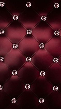 an upholstered wall with diamonds on it's back and red velvet background