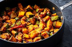 a pan filled with cooked vegetables on top of a table