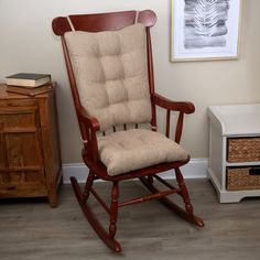 a wooden rocking chair sitting next to a dresser