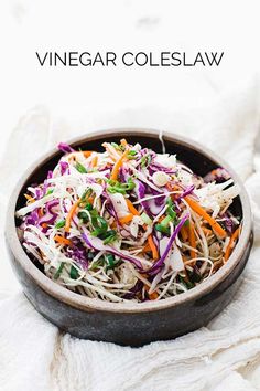 a bowl filled with coleslaw and carrots on top of a white blanket